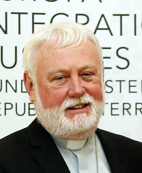 Archbishop Paul Richard Gallagher, white-haired and bearded, in clerical black